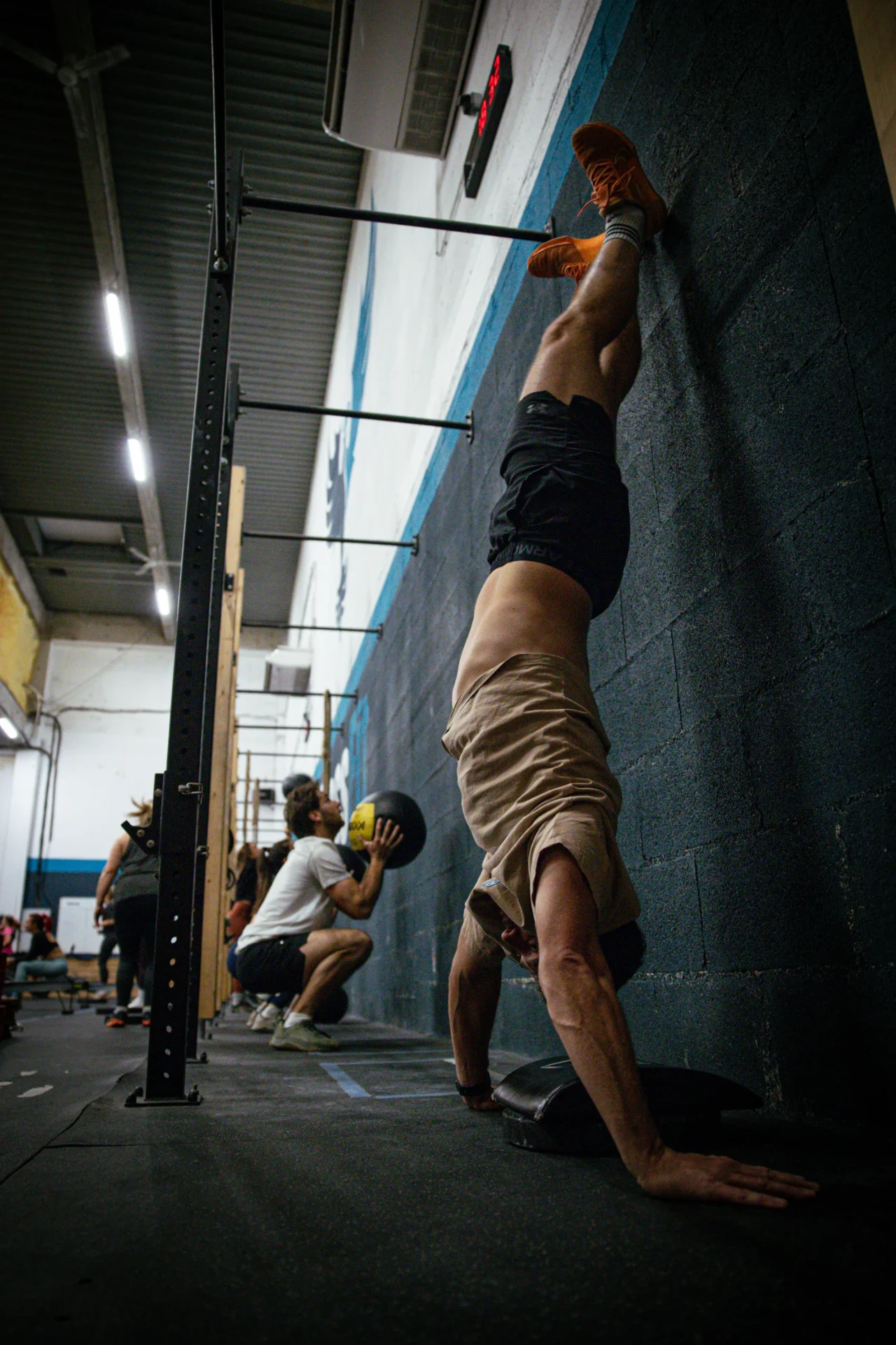 Handstand contre le mur pendant un entraînement de gymnastique CrossFit